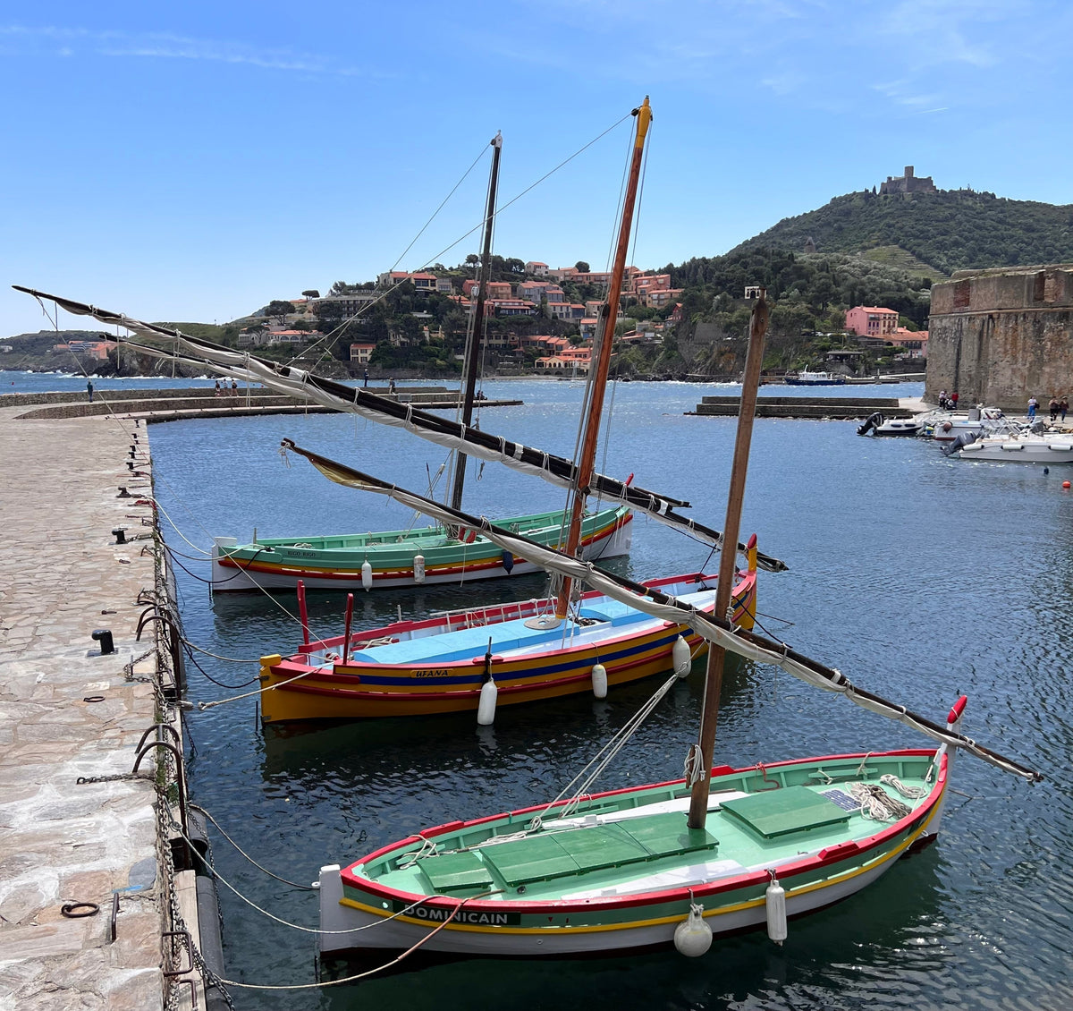 Fisherman working at Collioure harbor sunrise