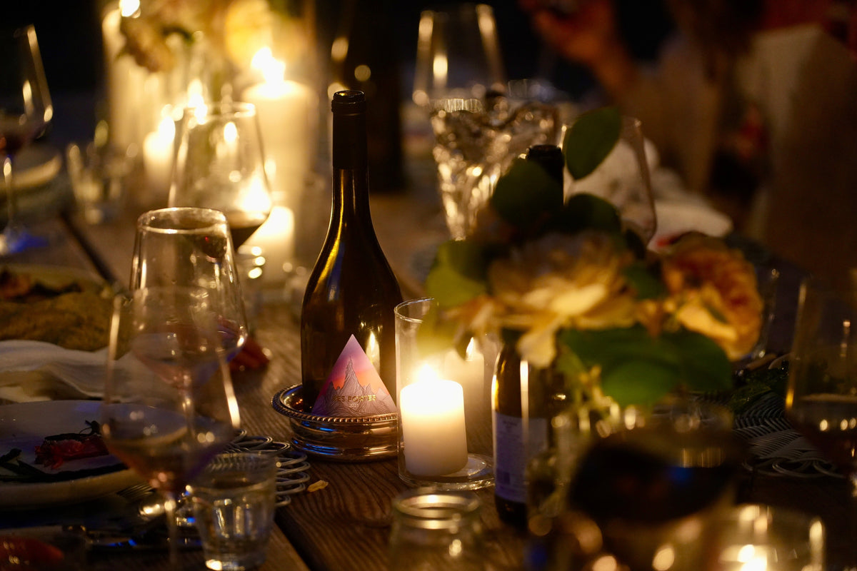 Woman pouring GMS wine at kitchen table